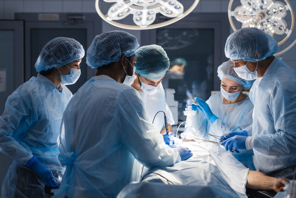 A team of surgeons performing a procedure on a sedated patient in an operating room